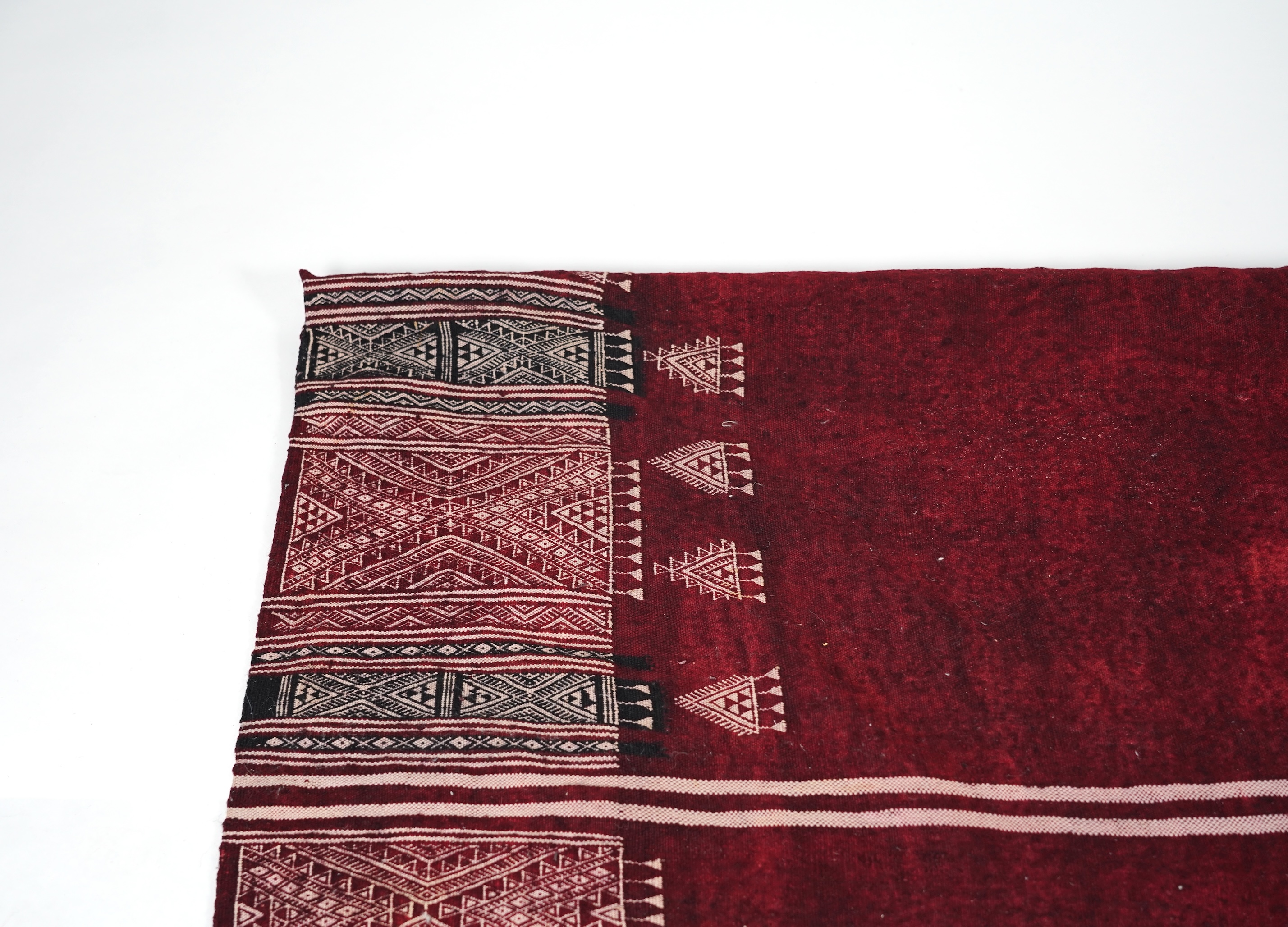 A Tunisian Amazigh, Berber maroon and white woven wool wall hanging, possibly 107 x 125cm
